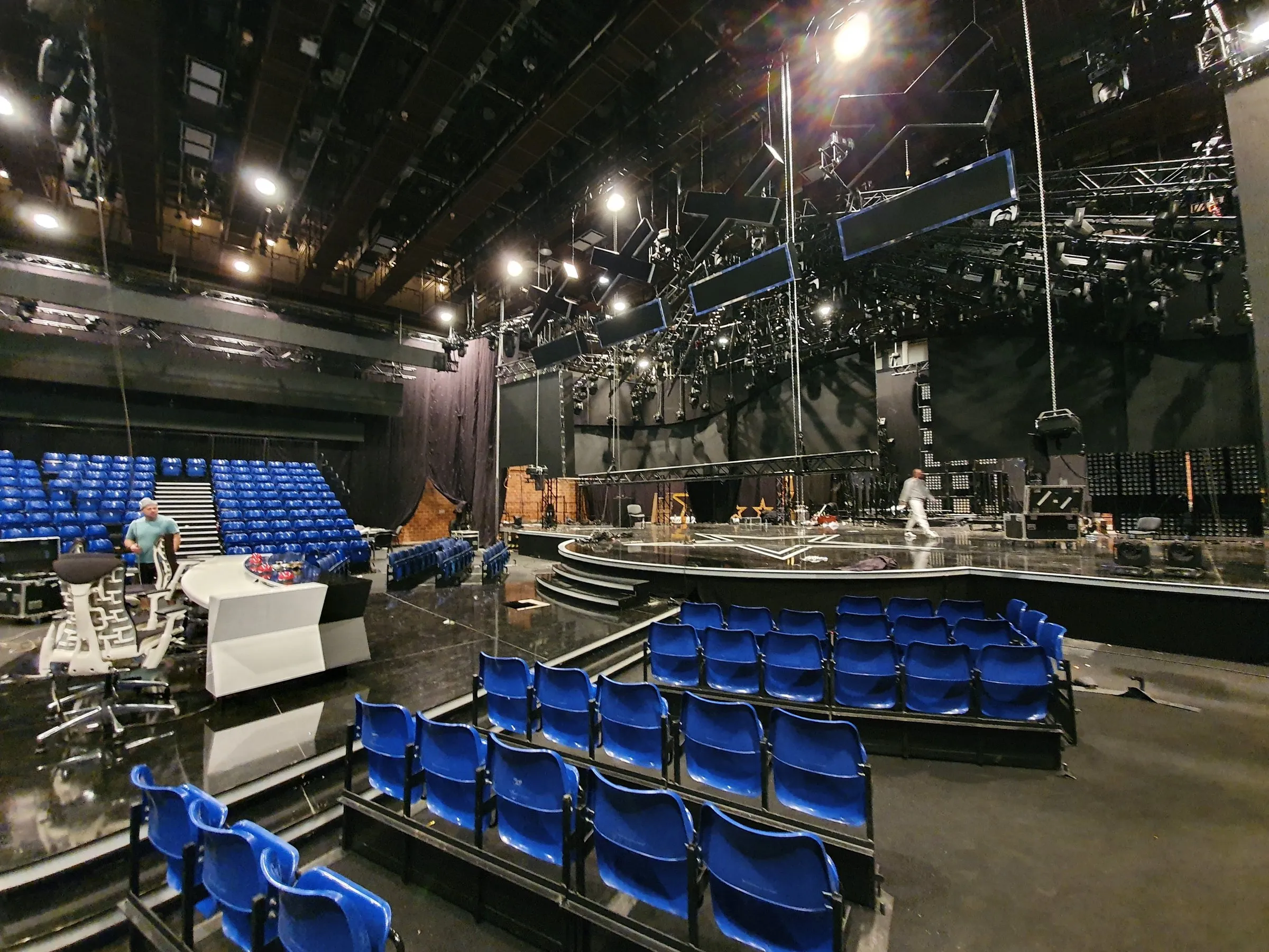 Arenaseats stand facing a TV studio set